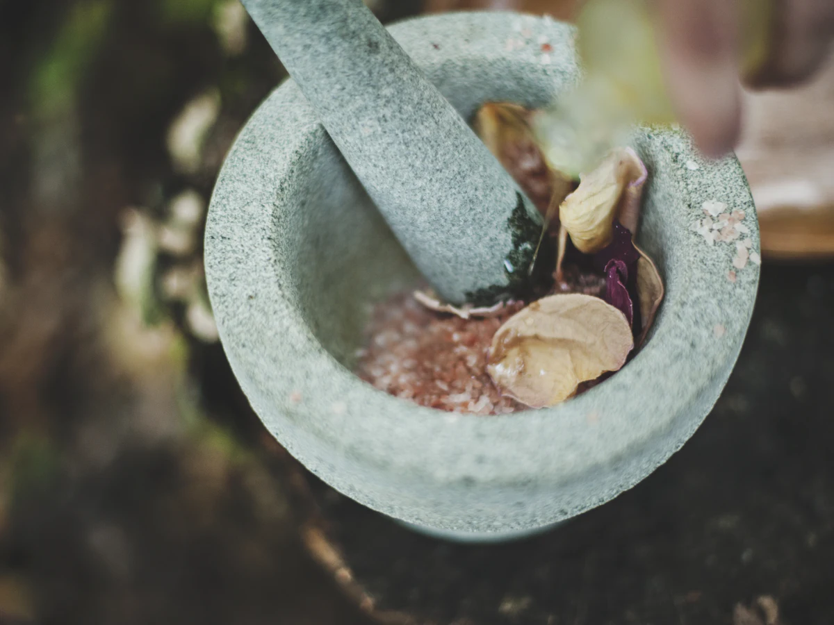 Natural medicine being prepared in a stone mortar